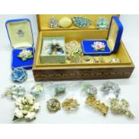 Approximately fifty brooches in a jewellery box