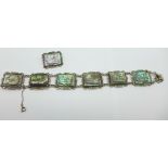 A carved abalone panel bracelet, set in silver with marcasite detailing, with a matching brooch,