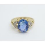 A 9ct gold and blue stone ring with diamond shoulders, 2.2g, J, (stone scratched)