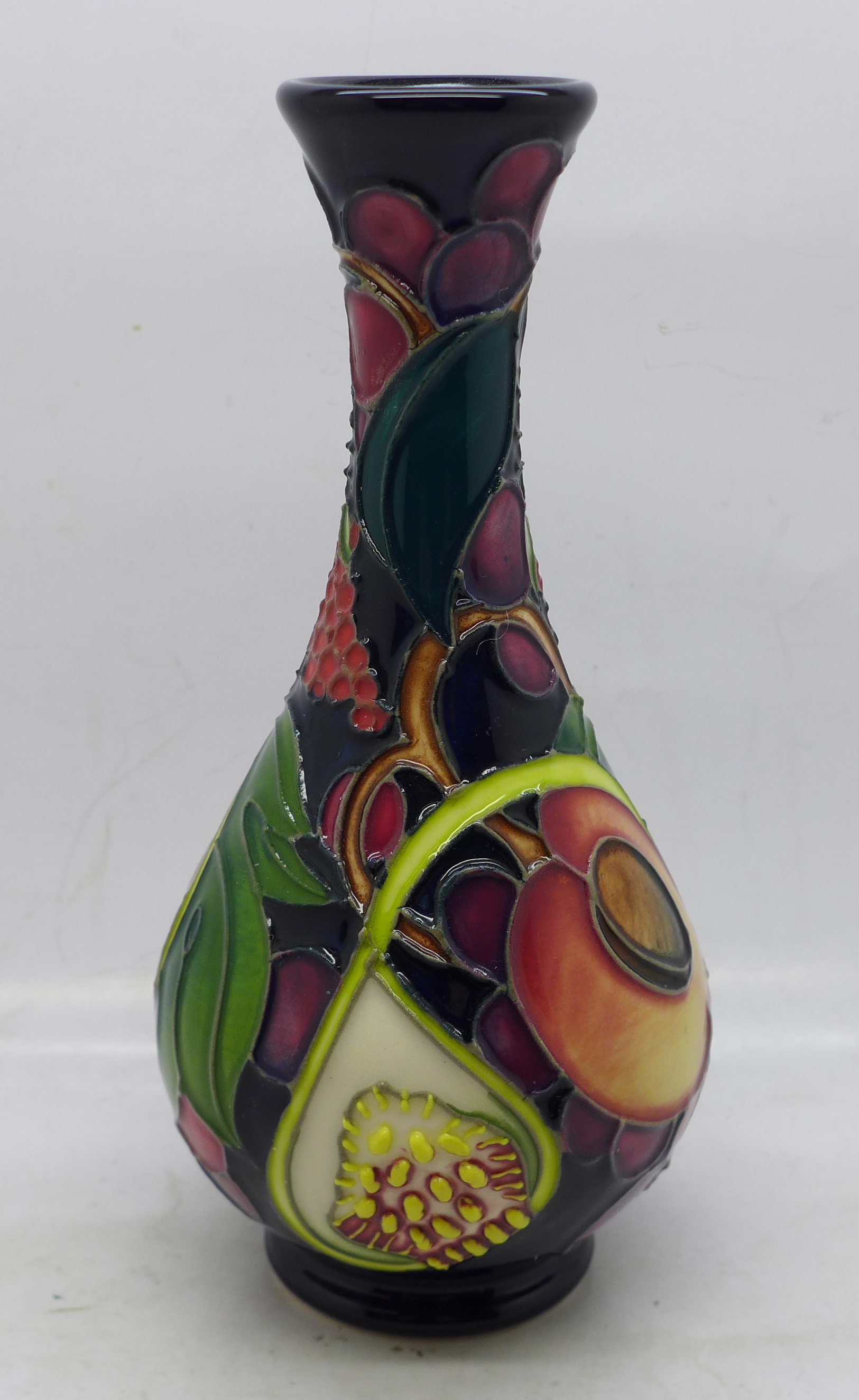 A Moorcroft vase (shape no. QC80/6) Queens Choice pattern, 17cm