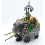 A gem set and white metal embellished carved wooden Indian elephant, 13.5cm, a/f