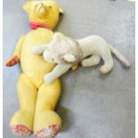 A Teddy bear with growler and a soft toy lion