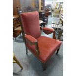 A Victorian carved oak and upholstered armchair