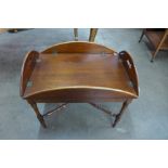 A Victorian style mahogany butlers tray on stand