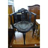 A Victorian ebonised elbow chair