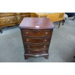 A small mahogany serpentine chest of drawers