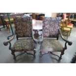 A pair of French carved carved walnut and upholstered fauteuils