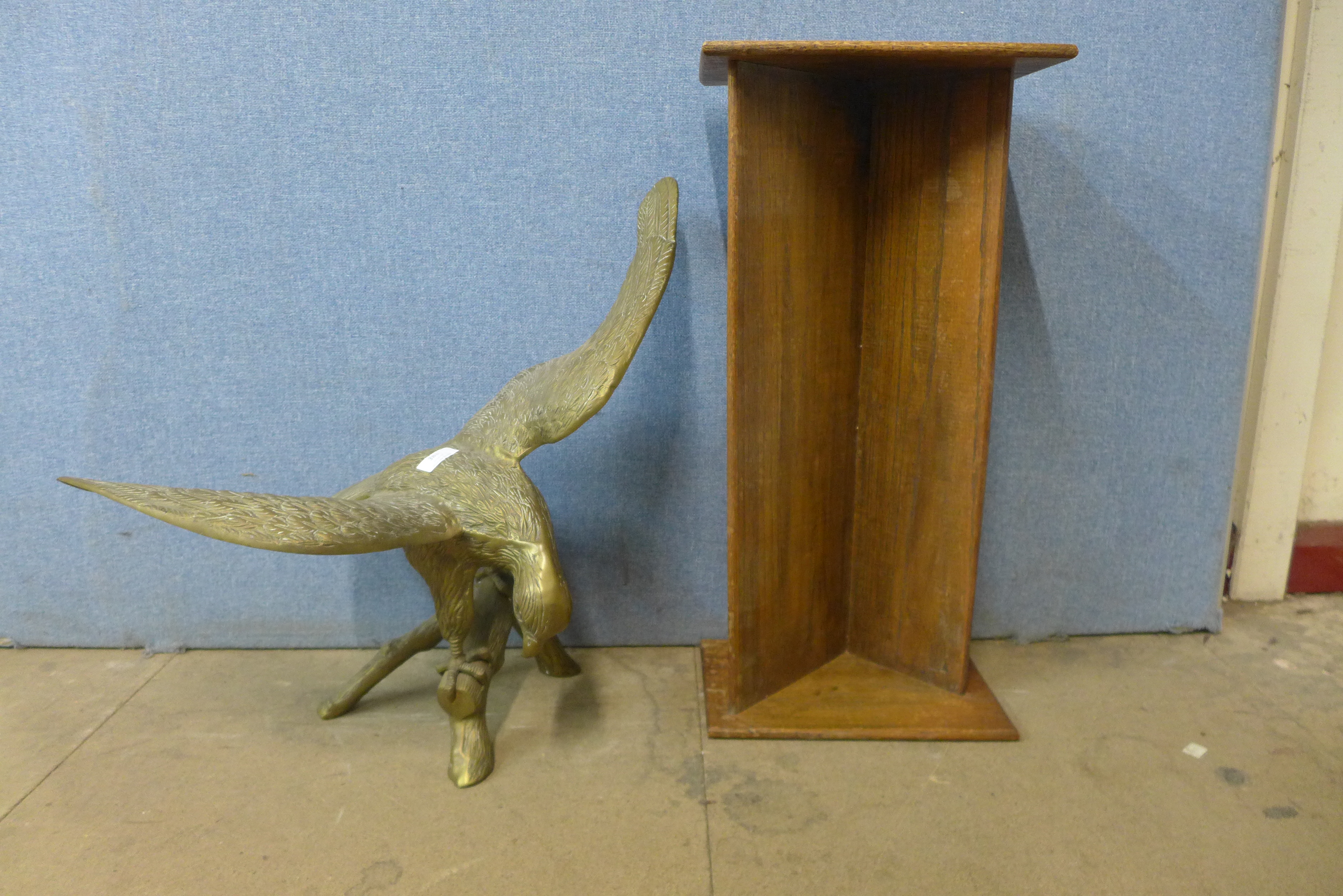 A large brass figure of an eagle and an oak book trough