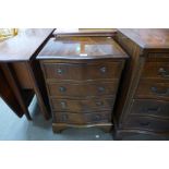 A small mahogany serpentine chest of drawers