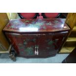 A small Chinese red chinoiserie lacquered two door cabinet