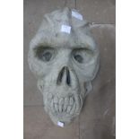 A concrete primate skull garden ornament