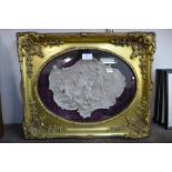 An Italian style faux marble plaque, in gilt frame