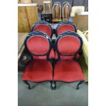 A set of four Victorian style ebonised dining chairs