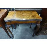 A George I style walnut serpentine fold over card table