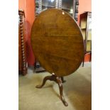 A George III oak circular tilt-top tripod tea table