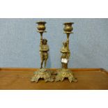 A pair of brass figural candlesticks