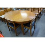 A teak extending dining table and four chairs