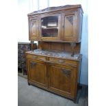 An early 20th century French carved oak and marble topped buffet sideboard