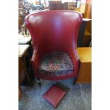 A George III style mahogany and faux red leather armchair and footstool