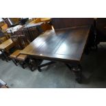 A large oak draw-leaf table and four chairs