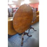 A George III oak circular tilt-top tea table