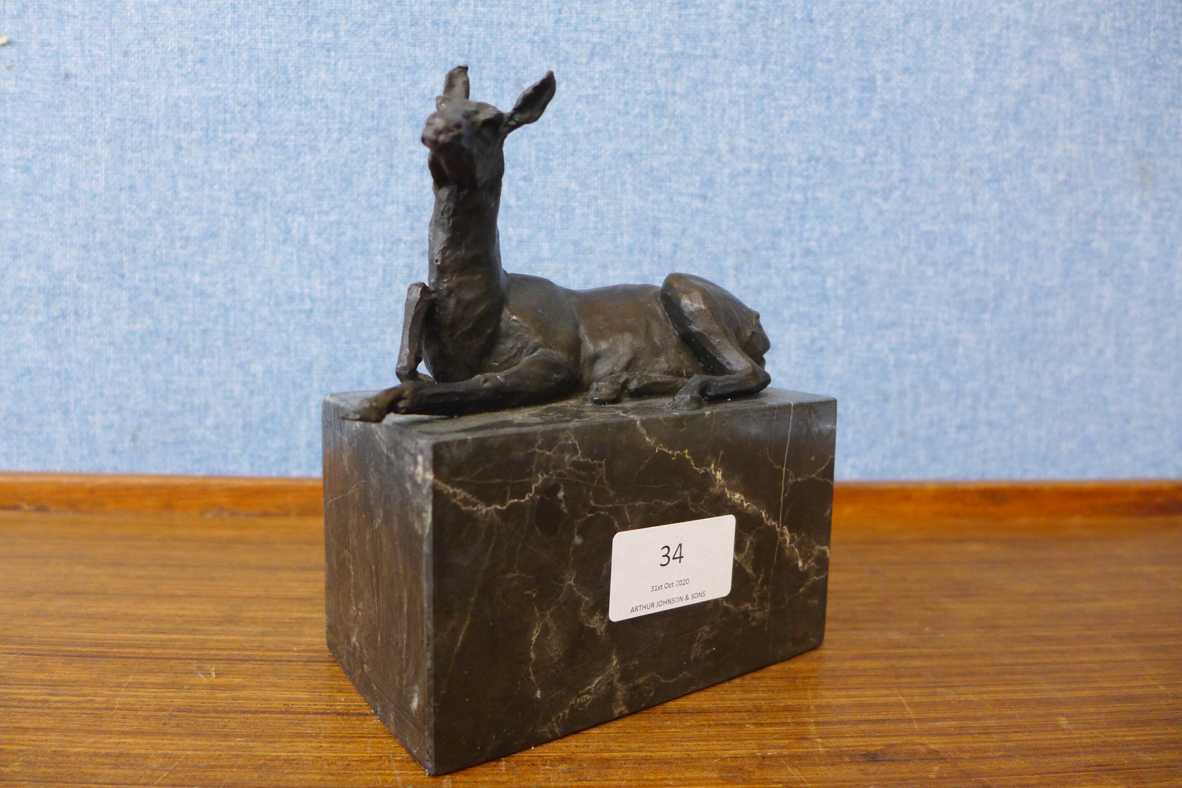 A small bronze figure of a horse, on black marble socle