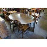 An Old Charm oak extending dining table and four chairs