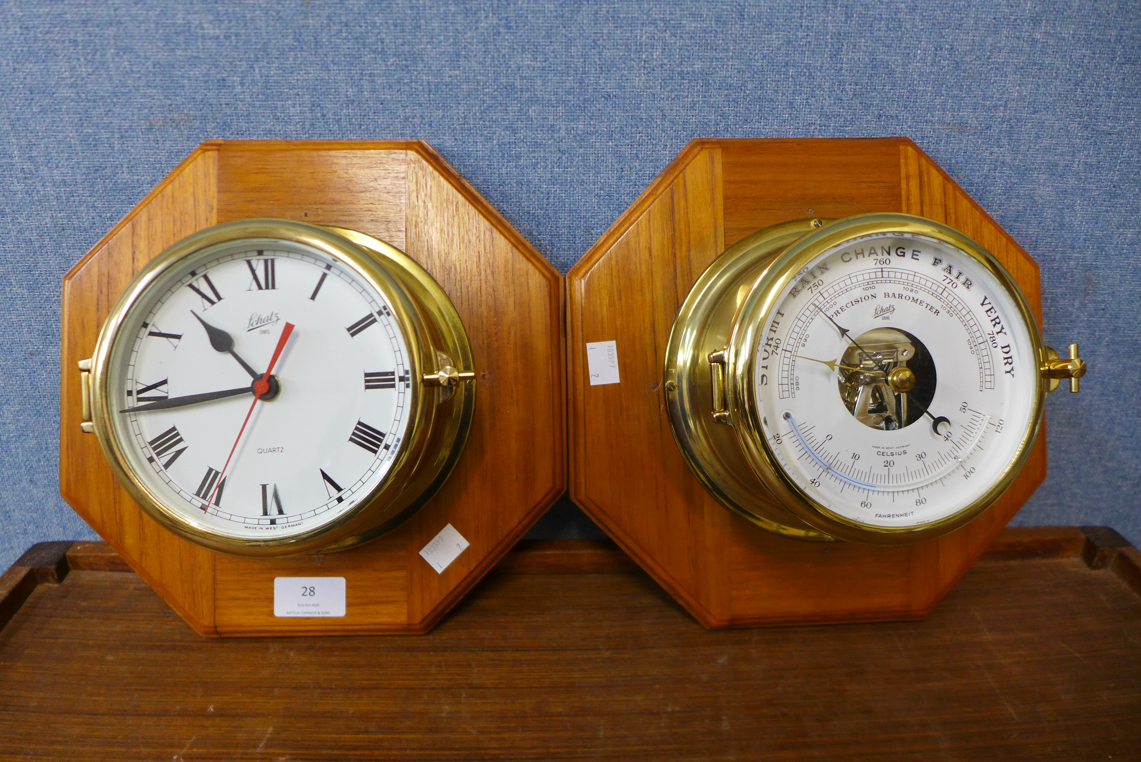 A Schatz marine aneroid barometer and matching wall clock, mounted on oak octagonal plinths