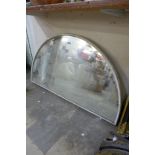 An arched painted framed mirror