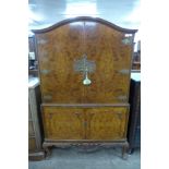 A burr walnut fitted cocktail cabinet