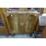 A carved oak two door display cabinet