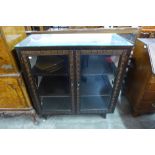 A Chinese carved ebonised display cabinet