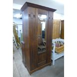 An Arts and Crafts oak wardrobe