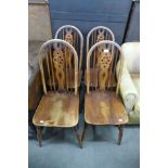 A set of four beech wheelback kitchen chairs