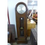 An early 20th Century oak electric longcase clock