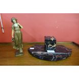 An Art Deco marble inkwell and a faux ivory and gilt metal figure of a water carrier