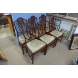 A Regency style mahogany dining table and six Hepplewhite Revival mahogany dining chairs