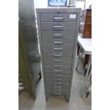 A grey metal fifteen drawer cabinet