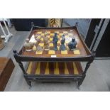 A games compendium trolley with chess board and pieces