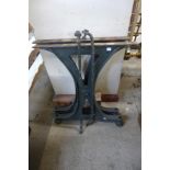 A cast iron trestle table base