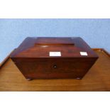 A Victorian flame mahogany sarcophogus shaped tea caddy