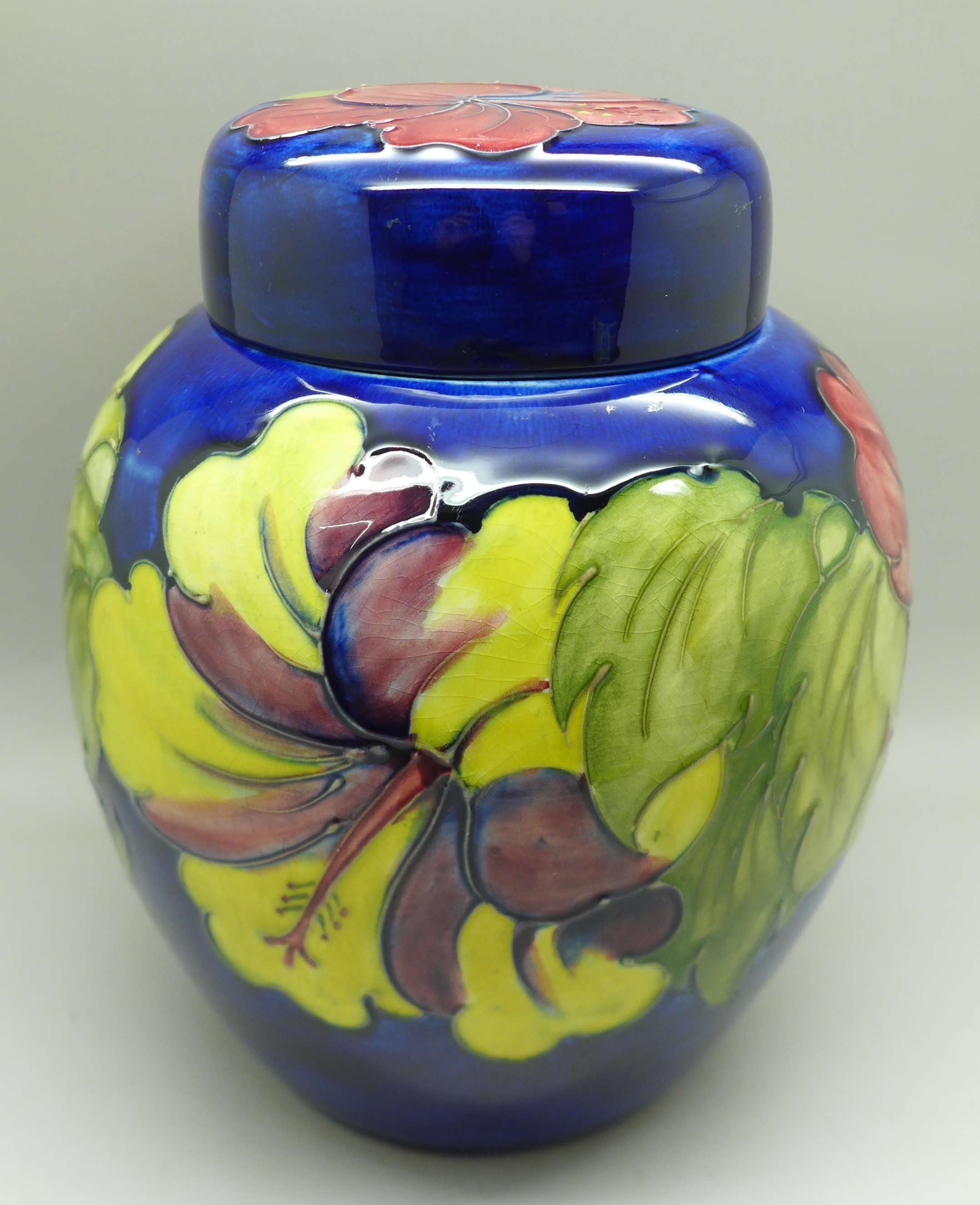 A Moorcroft hibiscus ginger jar on blue ground, signed, with paper label inside lid, 20cm - Image 3 of 9