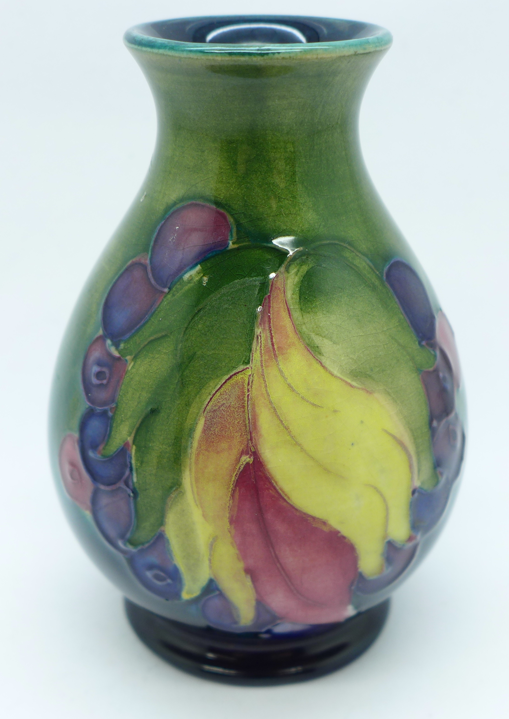 A Moorcroft Leaves and Fruit vase, with impressed signature and Potter to H.M. The Queen marks, 9cm