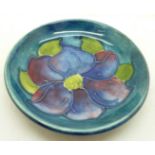 A small Moorcroft clematis dish, with paper label, The Late Queen Mary, 77mm diameter