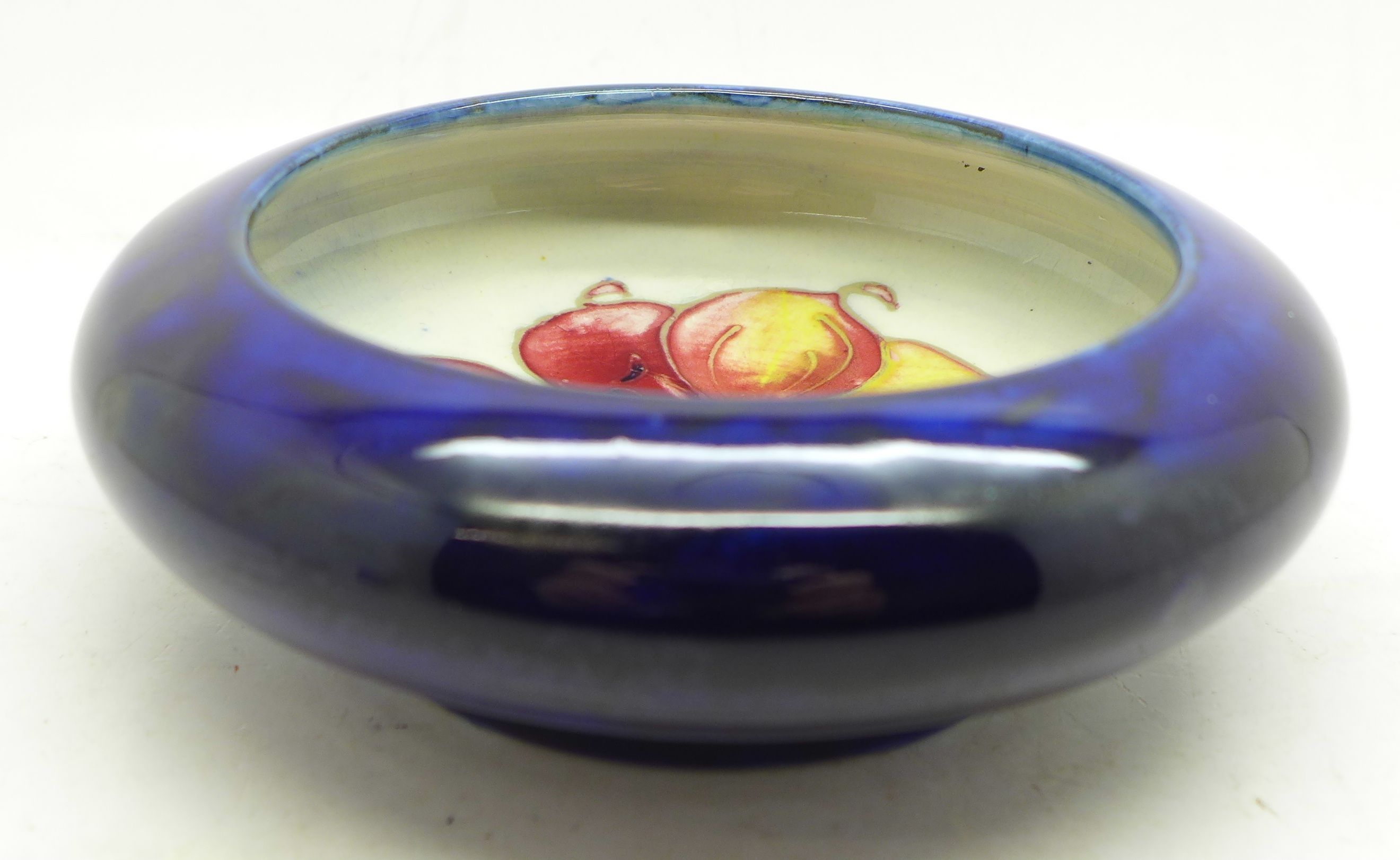 A Moorcroft bowl, with paper label, By Appointment to H.M. The Queen, 11cm diameter