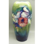 A Moorcroft orchid table lamp base, impressed signature and Potter To HM The Queen on the base, 25.