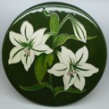 A Moorcroft Bermuda Lily plate, with paper label, The Late Queen Mary, crazed, 308mm