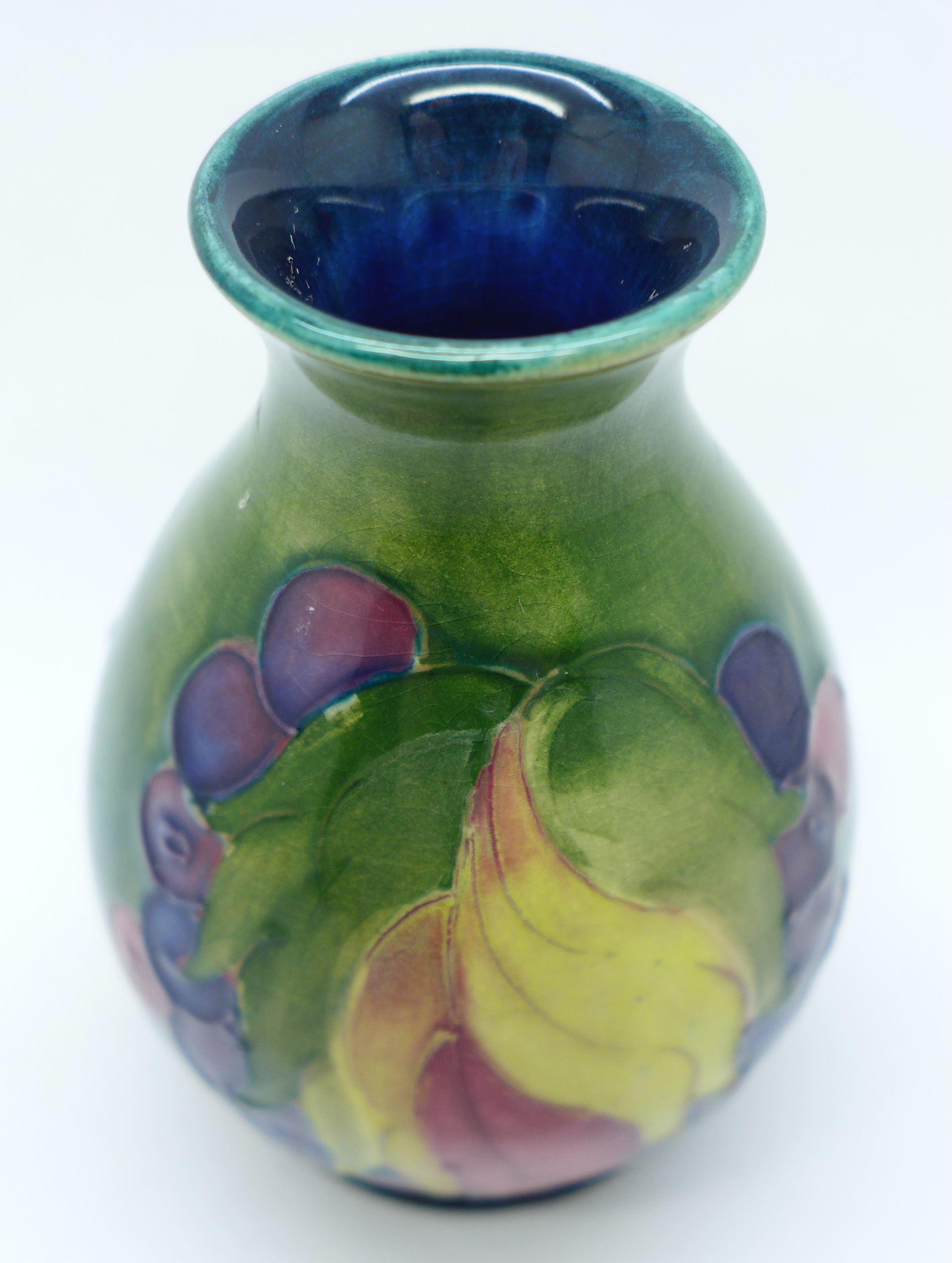 A Moorcroft Leaves and Fruit vase, with impressed signature and Potter to H.M. The Queen marks, 9cm - Image 2 of 5