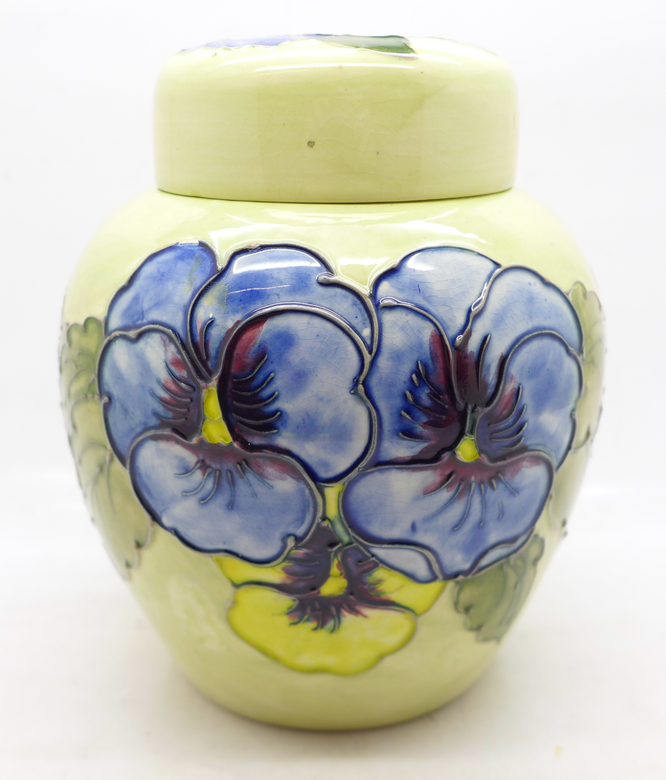 A Moorcroft pansy ginger jar, with red paper label, label a/f, 14cm