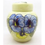 A Moorcroft pansy ginger jar, with red paper label, label a/f, 14cm